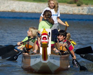 Image of group of kids dragon boating on the Oklahoma River