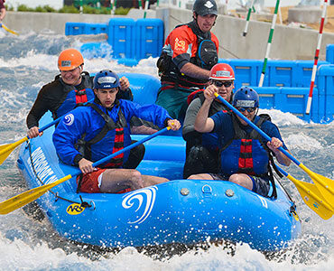 Image of group of men whitewater rafting at RIVERSPORT Rapids