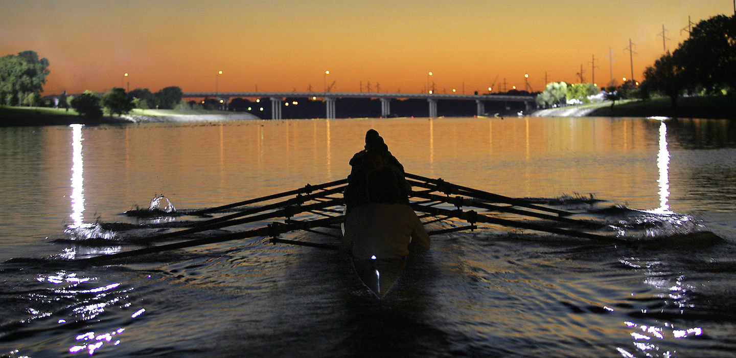 Image of four rowers on the Oklahoma River at sunset