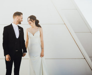 Image of bride and groom laughing outside CHK|Central Boathouse