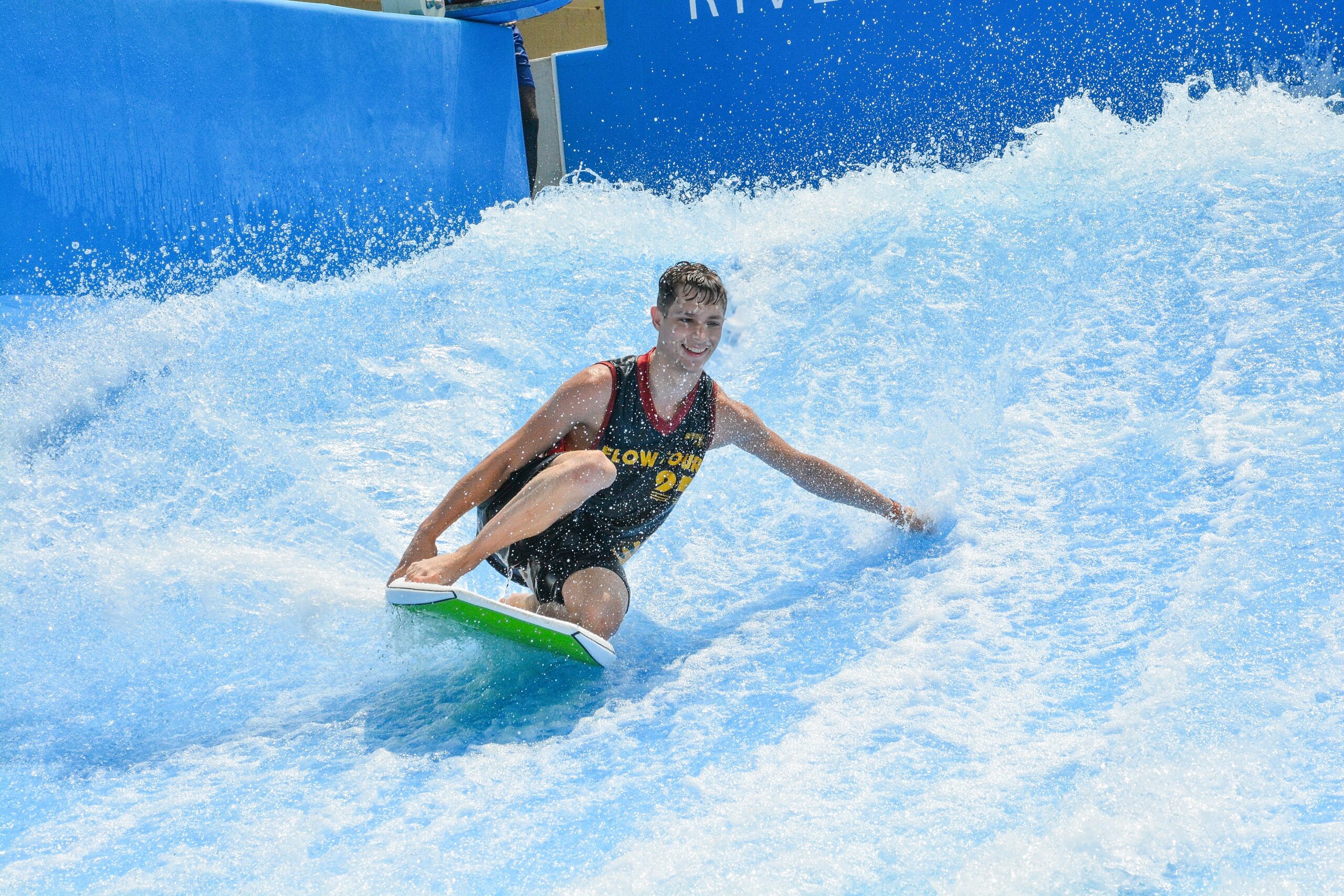 Smiling man surfing on SurfOKC